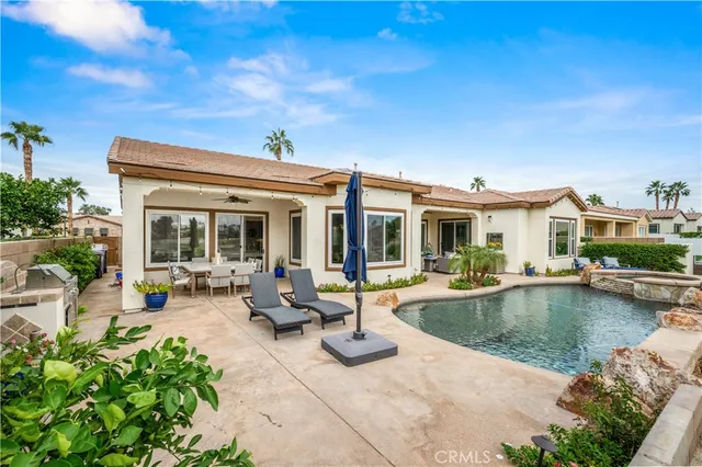 a view of a swimming pool and lounge chairs