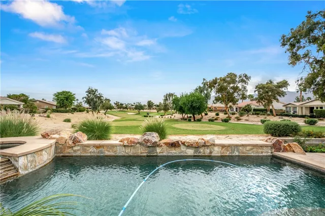 a view of swimming pool with a balcony