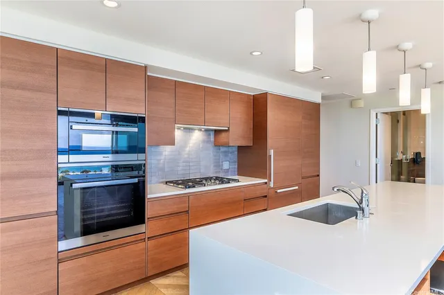 a kitchen with stainless steel appliances granite countertop a sink and a stove
