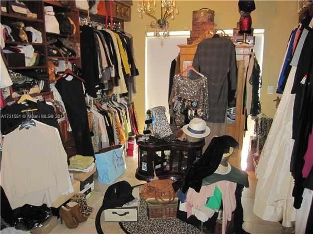 3749 Southwest 27th Lane, Unit 3749 Miami, FL 33134 - Photo 12 of 16 a view of walk in closet with clothes and shoes