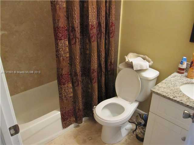 3749 Southwest 27th Lane, Unit 3749 Miami, FL 33134 - Photo 13 of 16 a bathroom with a granite countertop toilet and a sink