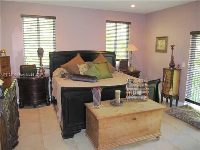 3749 Southwest 27th Lane, Unit 3749 Miami, FL 33134 - Photo 6 of 16 a bedroom with a bed and wooden floor