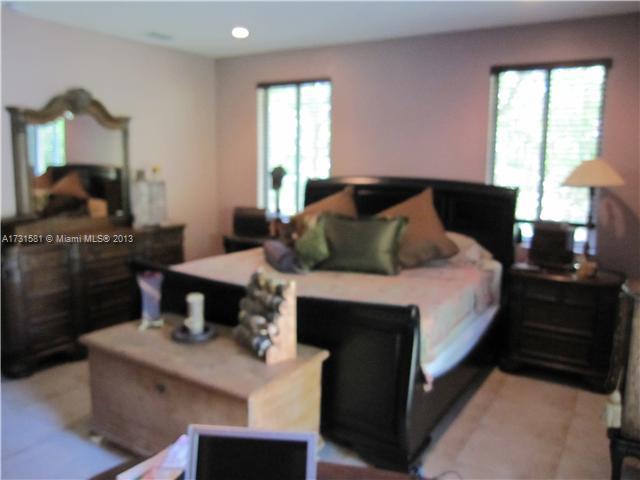 3749 Southwest 27th Lane, Unit 3749 Miami, FL 33134 - Photo 7 of 16 a bedroom with a bed and a potted plant
