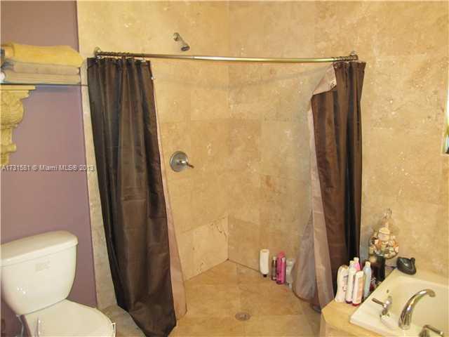 3749 Southwest 27th Lane, Unit 3749 Miami, FL 33134 - Photo 8 of 16 a bathroom with a toilet and a shower