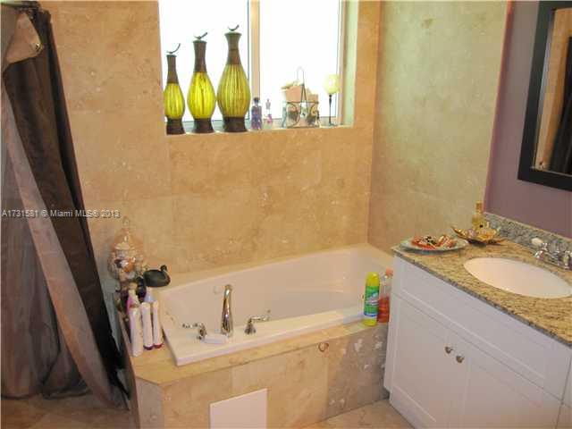 3749 Southwest 27th Lane, Unit 3749 Miami, FL 33134 - Photo 9 of 16 a bathroom with a tub sink and mirror