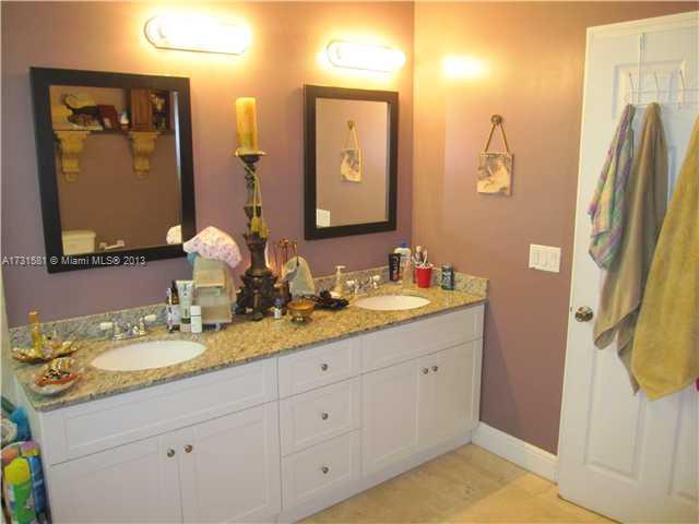 3749 Southwest 27th Lane, Unit 3749 Miami, FL 33134 - Photo 10 of 16 a bathroom with a double vanity sink and a mirror