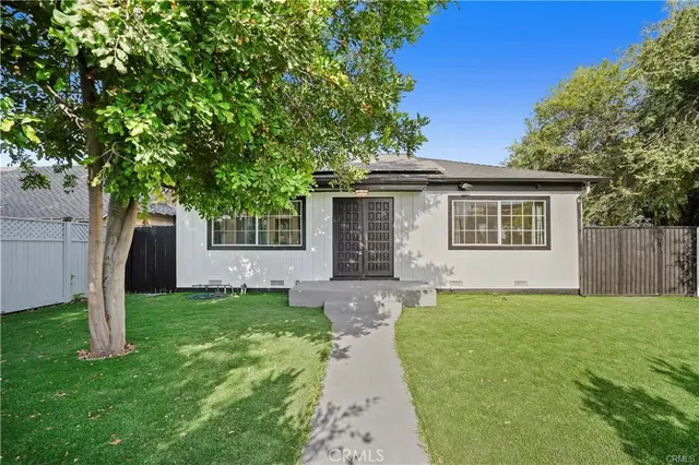 a front view of a house with a yard and a garage