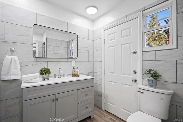 a bathroom with a sink a toilet and mirror