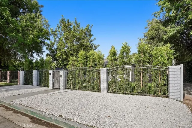 a wooden fence with trees in the background