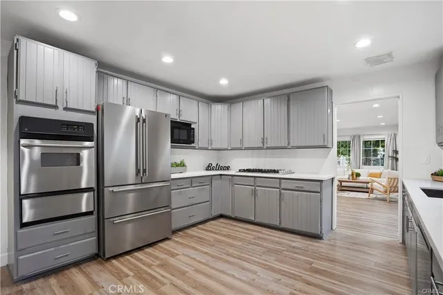 a kitchen with granite countertop stainless steel appliances and wooden cabinets