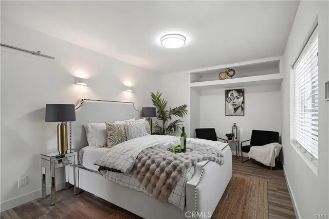 a large bedroom with a bed and wooden floor