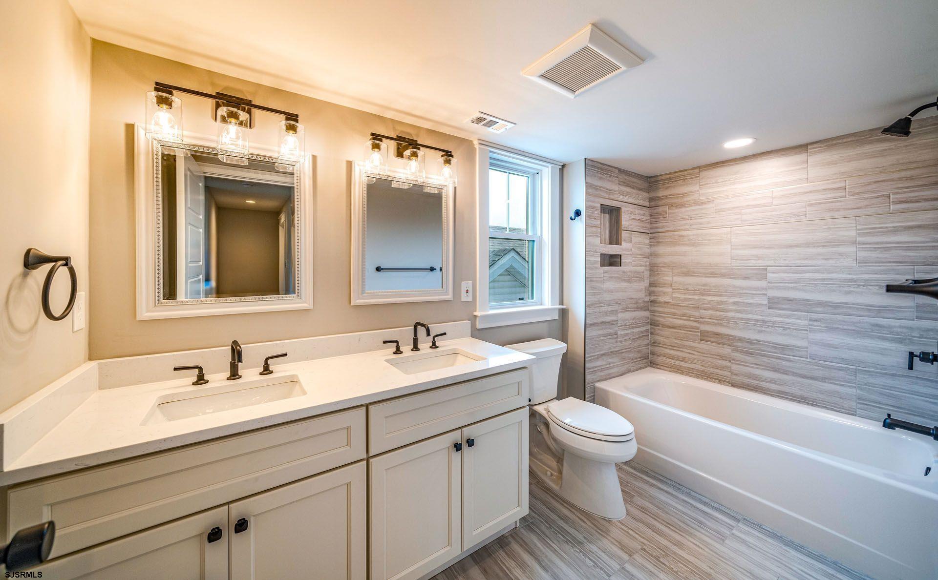 4 Wesley Road Ocean City, NJ 08226 - Photo 12 of 44 a bathroom with a double vanity sink mirror double and bathtub