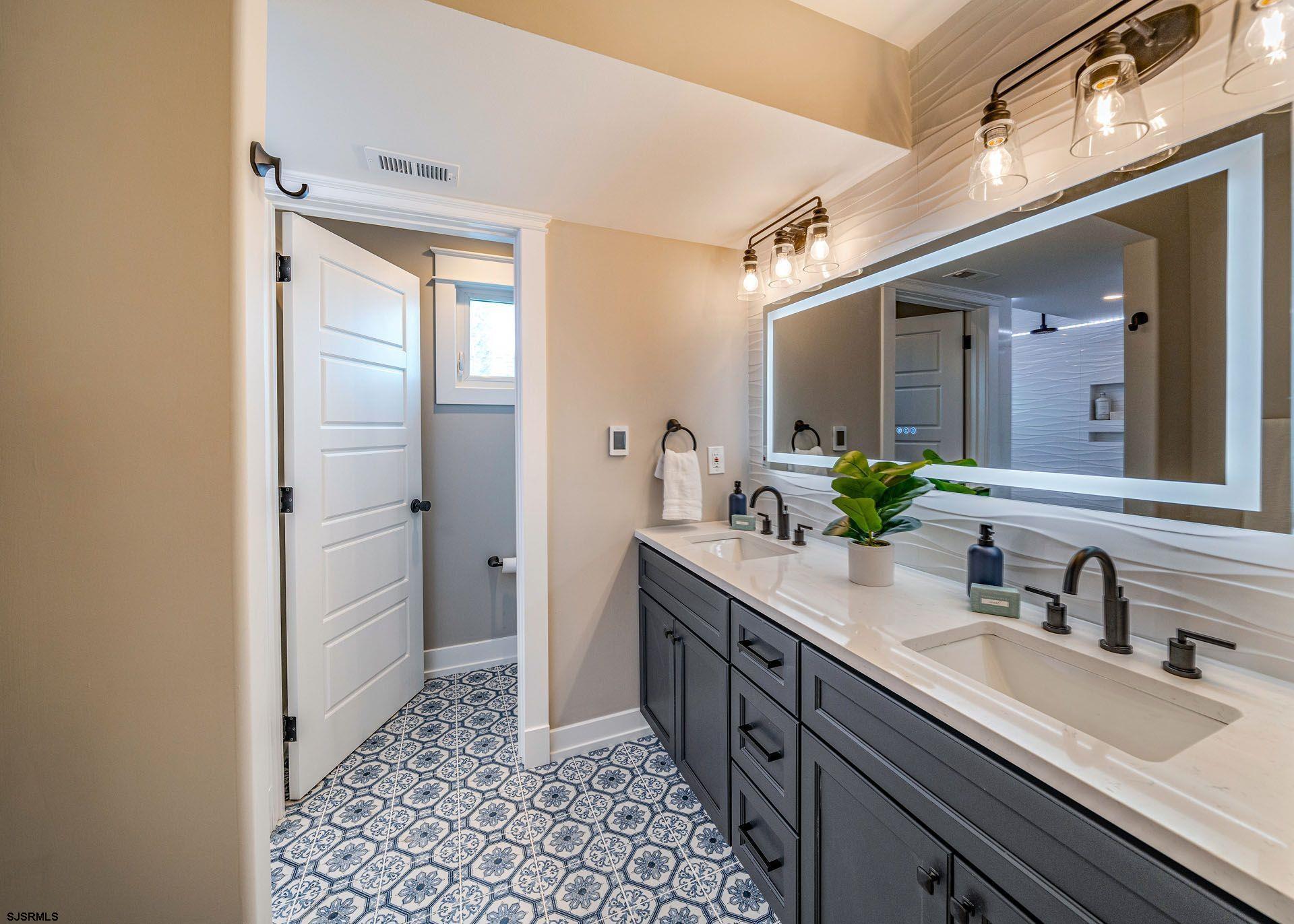 4 Wesley Road Ocean City, NJ 08226 - Photo 20 of 44 a spacious bathroom with a double vanity sink a mirror and a shower