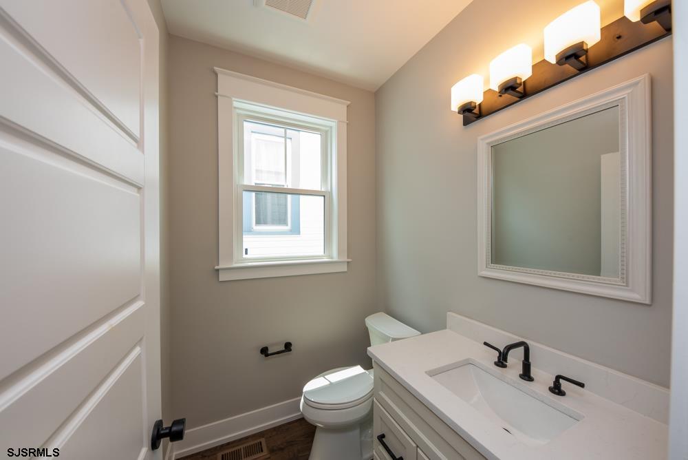 4 Wesley Road Ocean City, NJ 08226 - Photo 22 of 44 a bathroom with a toilet a sink and mirror