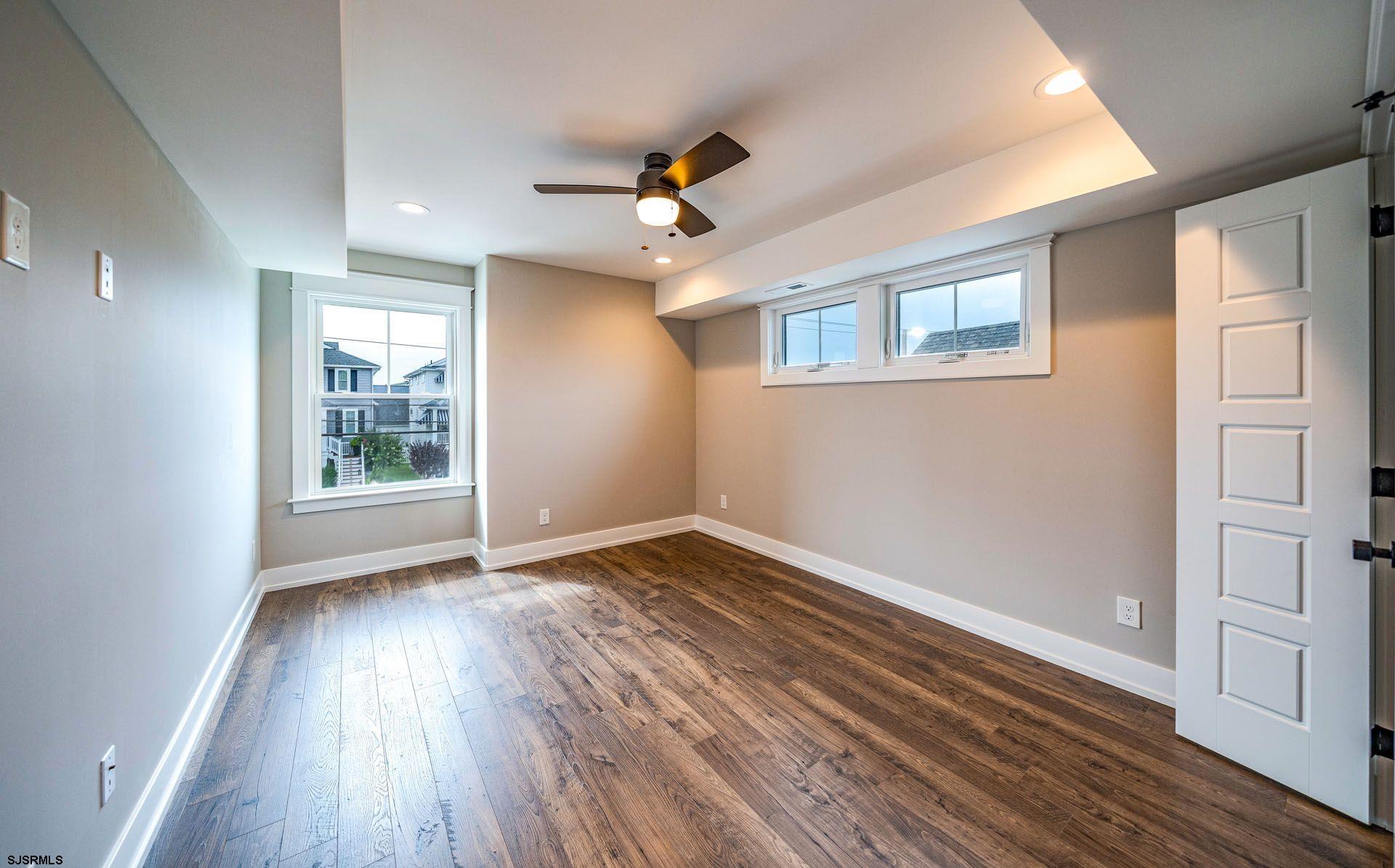 4 Wesley Road Ocean City, NJ 08226 - Photo 32 of 44 a view of an empty room with wooden floor and a window