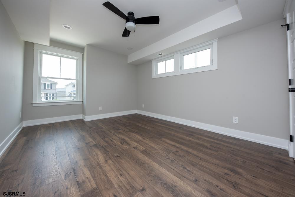 4 Wesley Road Ocean City, NJ 08226 - Photo 33 of 44 a view of an empty room with wooden floor and a window