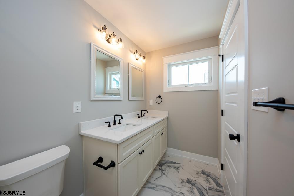 4 Wesley Road Ocean City, NJ 08226 - Photo 36 of 44 a bathroom with a double vanity sink mirror and toilet