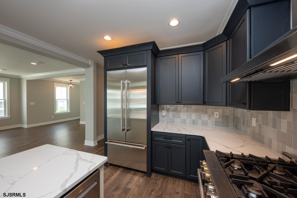 4 Wesley Road Ocean City, NJ 08226 - Photo 8 of 44 a kitchen with a wooden floor and a stove