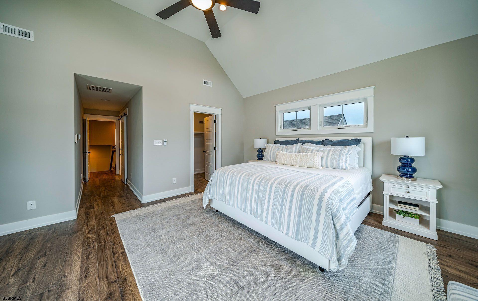 4 Wesley Road Ocean City, NJ 08226 - Photo 9 of 44 a bedroom with a bed and a chandelier