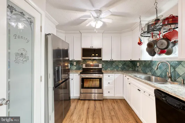 a kitchen with stainless steel appliances granite countertop a stove and a refrigerator