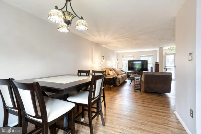 a view of a dining room with furniture wooden floor and a chandelier