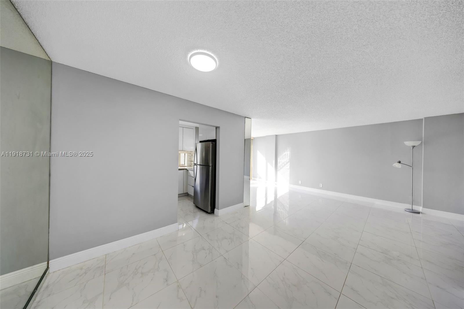 17011 North Bay Road, Unit 718 Sunny Isles Beach, FL 33160 - Photo 14 of 24 a view of a kitchen with a refrigerator and cabinet