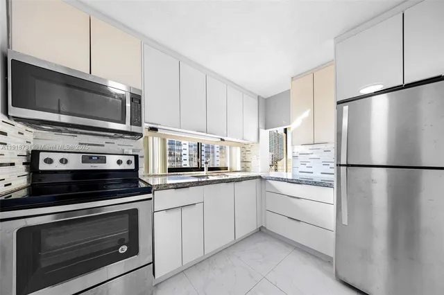 a bathroom with a granite countertop sink and a mirror with toilet