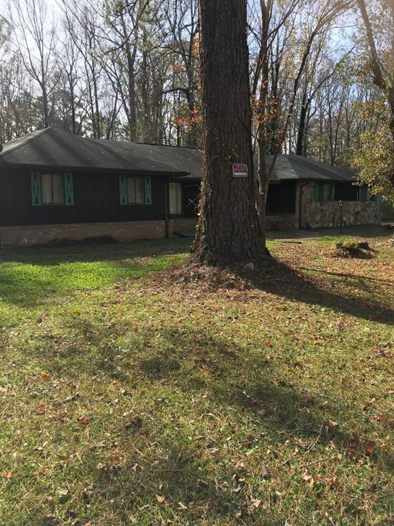 239 Panola Road Ellenwood, GA 30294 - Photo 1 of 1 a backyard of a house with lots of green space