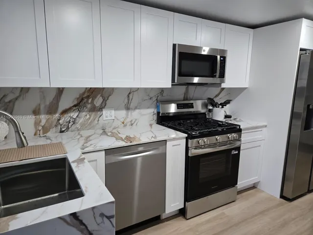 a kitchen with a stove and a microwave