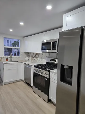 a kitchen with a stove microwave and sink
