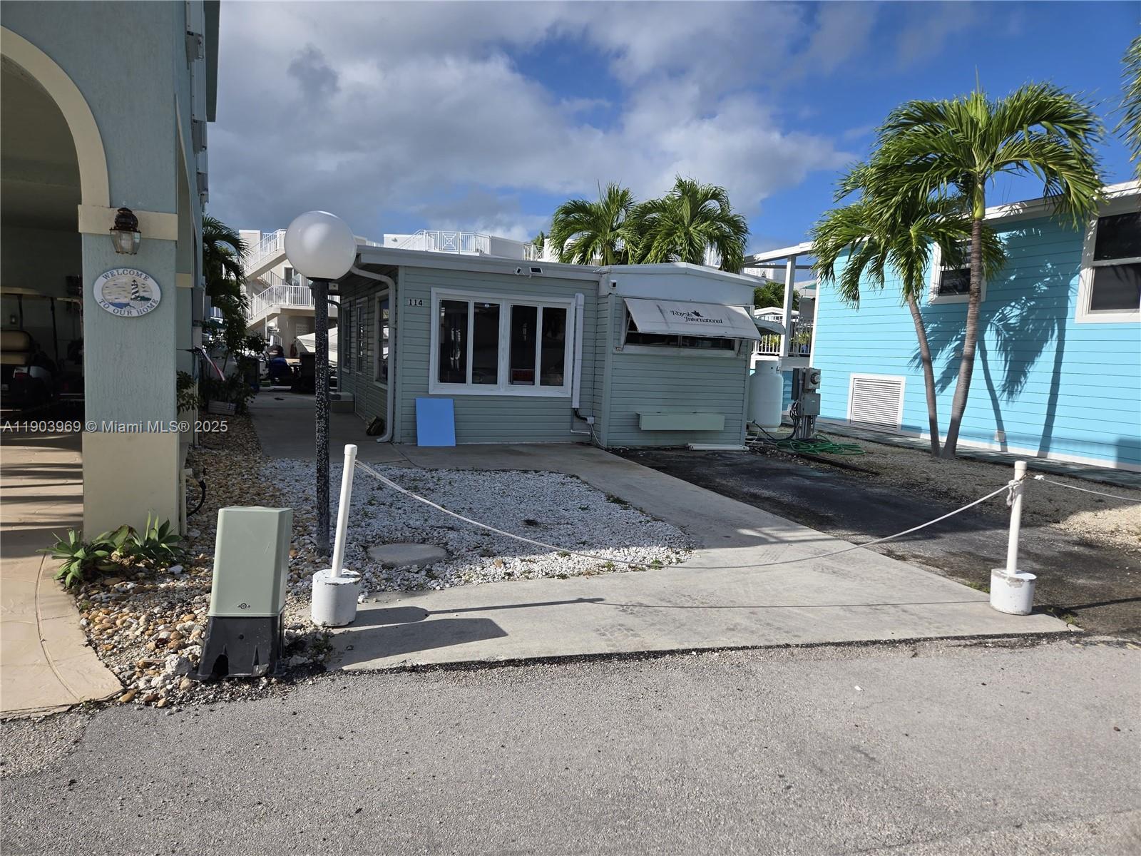 65821 Overseas Highway, Unit 114 Long Key, FL 33001 - Photo 5 of 7 a front view of a house with garden