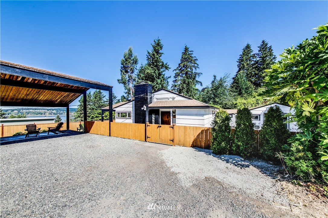 4401 Sunset Beach Road West University Place, WA 98466 - Photo 13 of 40 a view of a house with a yard and sitting area