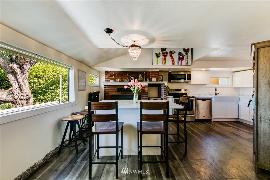 4401 Sunset Beach Road West University Place, WA 98466 - Photo 17 of 40 a view of a dining room with furniture window and wooden floor