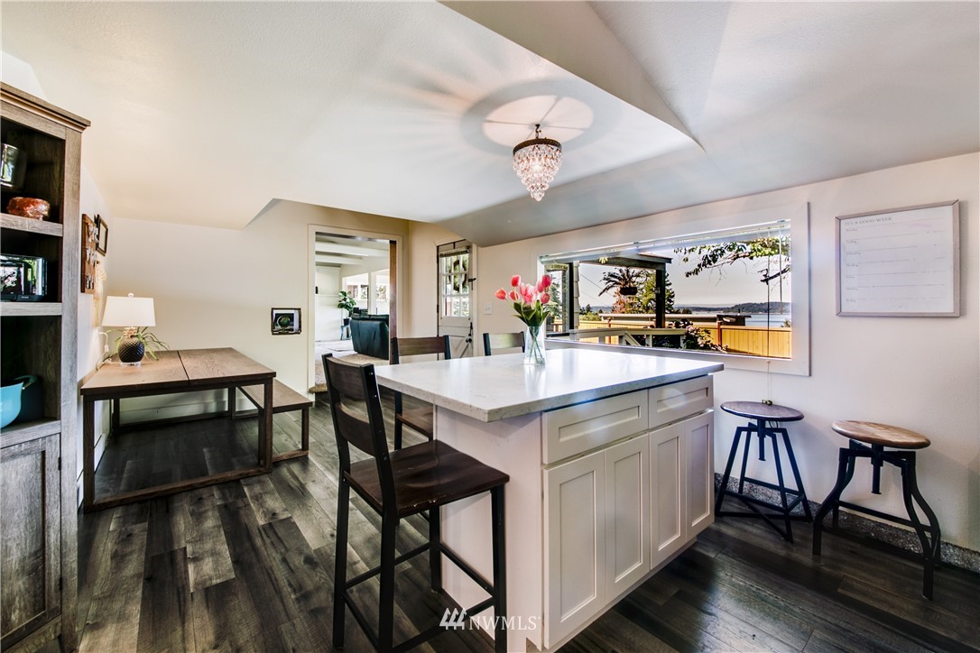 4401 Sunset Beach Road West University Place, WA 98466 - Photo 18 of 40 a view of kitchen island with furniture and wooden floor