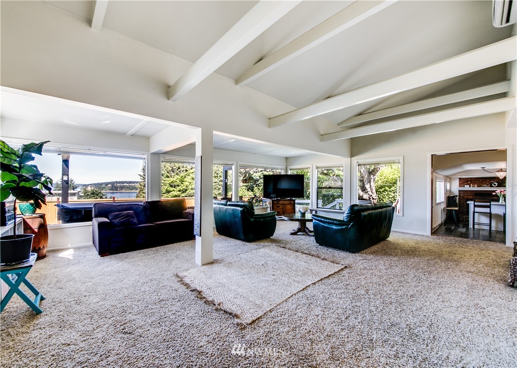 4401 Sunset Beach Road West University Place, WA 98466 - Photo 3 of 40 a living room with furniture fireplace and a large window