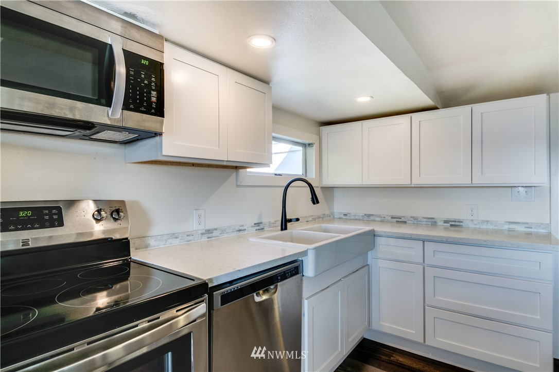 4401 Sunset Beach Road West University Place, WA 98466 - Photo 21 of 40 a kitchen with a sink cabinets and appliances