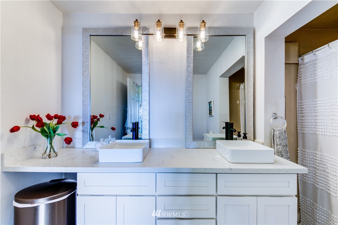 4401 Sunset Beach Road West University Place, WA 98466 - Photo 23 of 40 a bathroom with a sink and a mirror