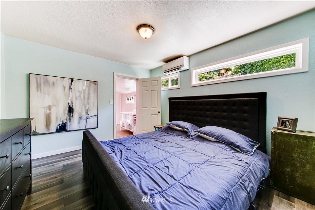 4401 Sunset Beach Road West University Place, WA 98466 - Photo 26 of 40 a bedroom with a bed and a large mirror on the dresser