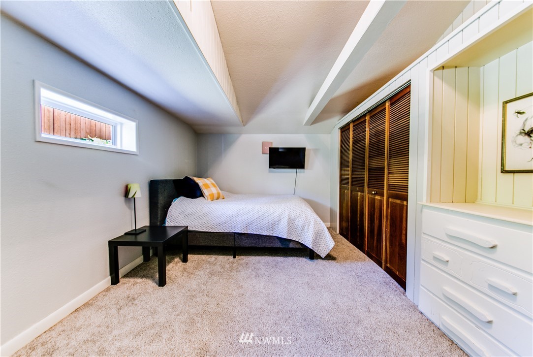 4401 Sunset Beach Road West University Place, WA 98466 - Photo 31 of 40 a bedroom with a bed and a window
