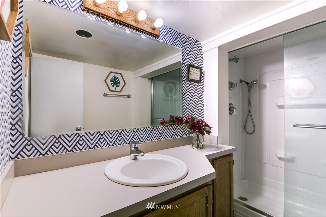 4401 Sunset Beach Road West University Place, WA 98466 - Photo 32 of 40 a bathroom with a sink and a mirror