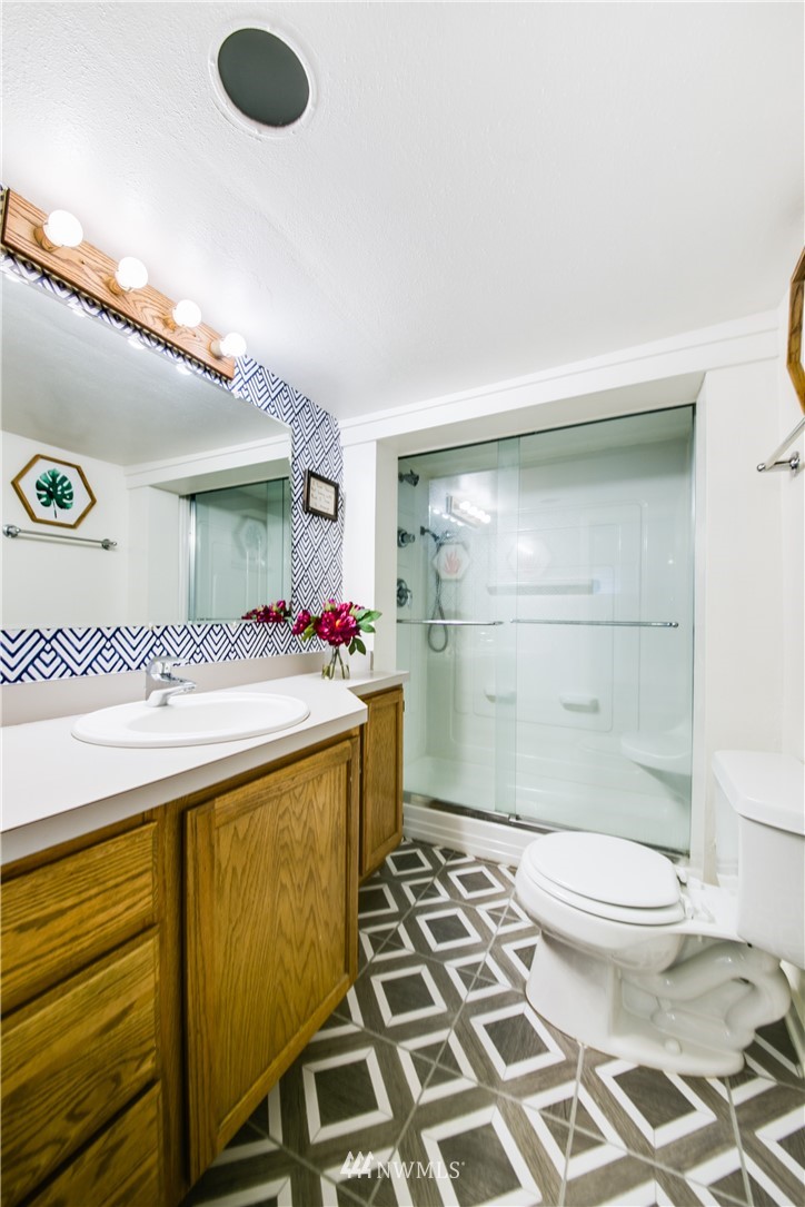 4401 Sunset Beach Road West University Place, WA 98466 - Photo 33 of 40 a bathroom with a sink a toilet and shower