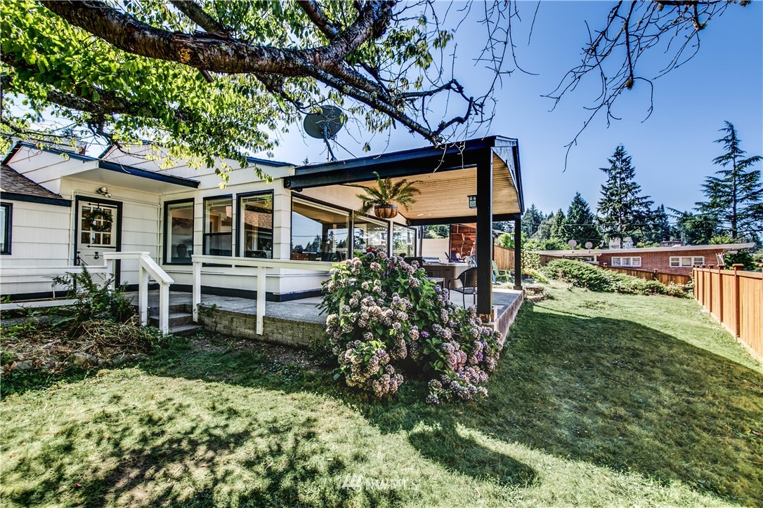 4401 Sunset Beach Road West University Place, WA 98466 - Photo 35 of 40 a view of a house with backyard and sitting area