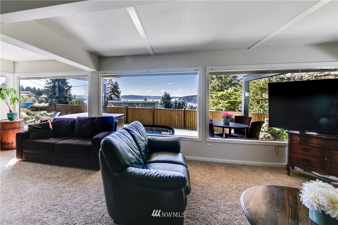 4401 Sunset Beach Road West University Place, WA 98466 - Photo 5 of 40 a living room with furniture and a flat screen tv