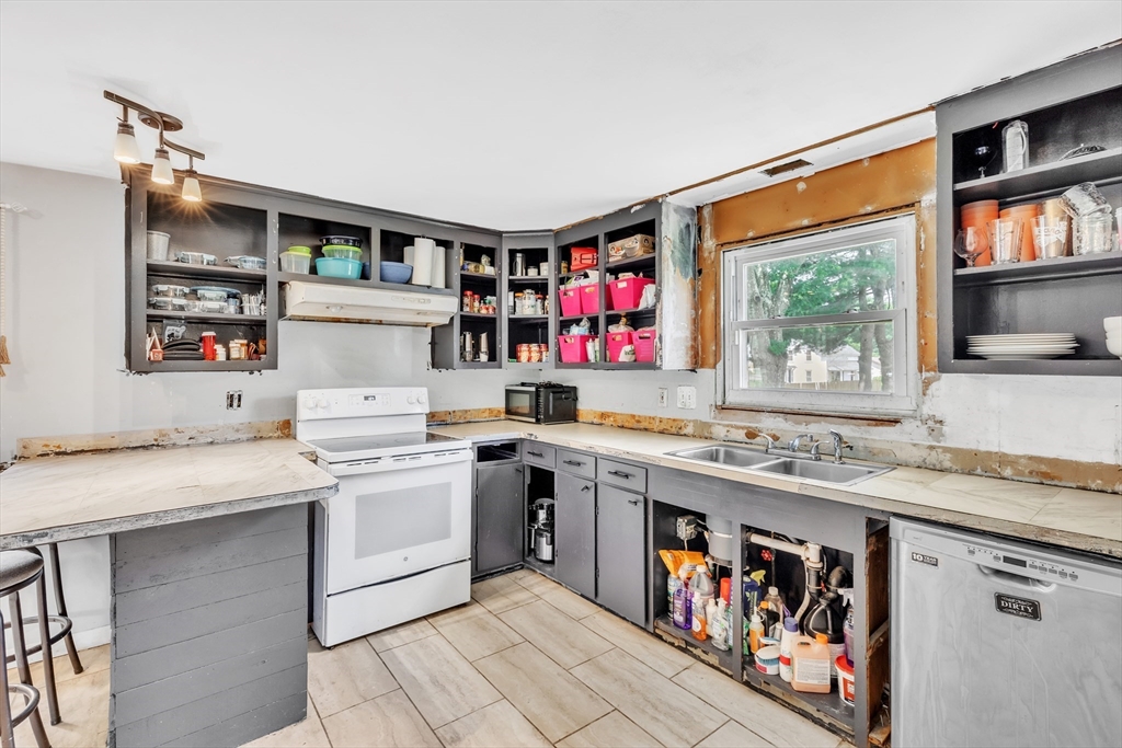 45 Ford Street, Unit A B Three Rivers, MA 01080 - Photo 18 of 42 a utility room with stainless steel appliances granite countertop a stove and a sink