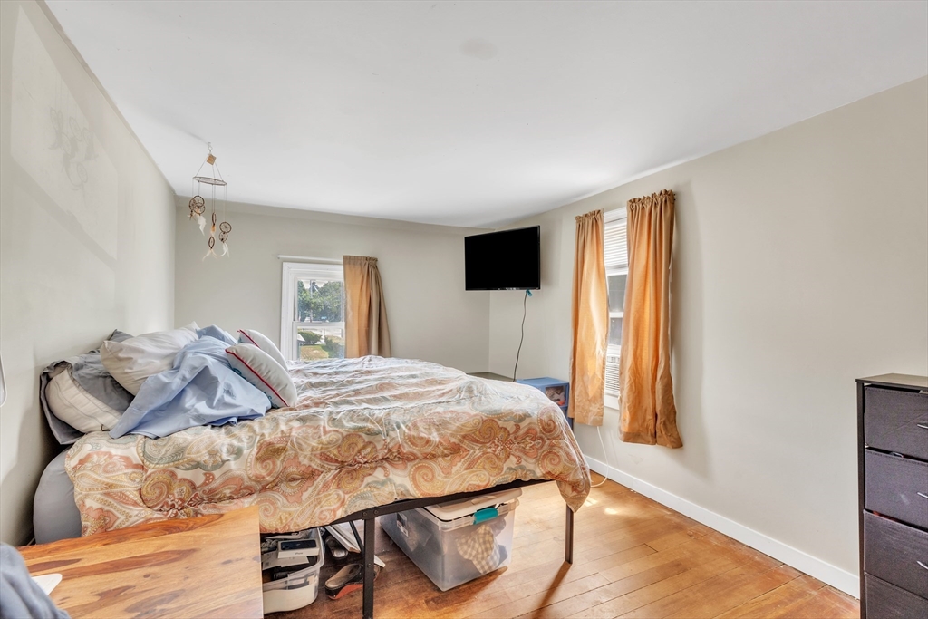 45 Ford Street, Unit A B Three Rivers, MA 01080 - Photo 35 of 42 a bedroom with a bed and wooden floor