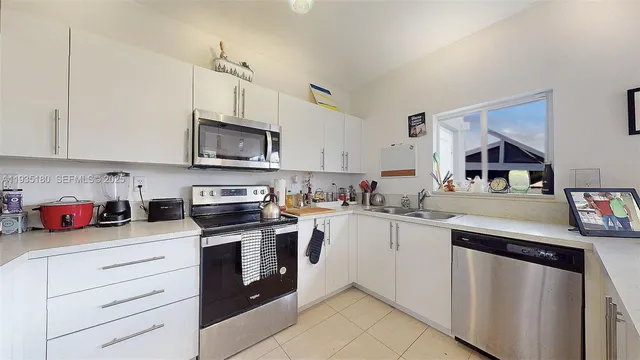 a kitchen that has a sink and cabinets in it