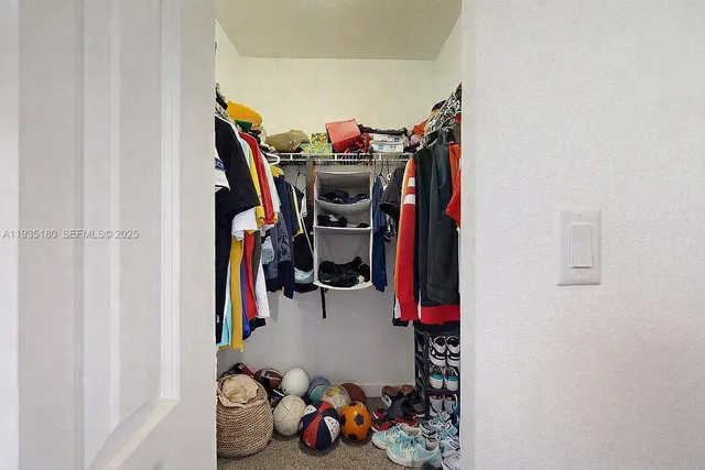 a bedroom with a bed and a dresser in it