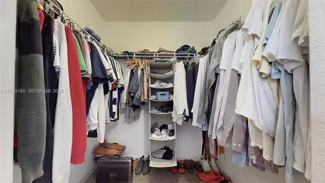 a bedroom with bed and wooden floor