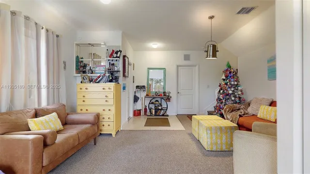 a living room with furniture and a chandelier