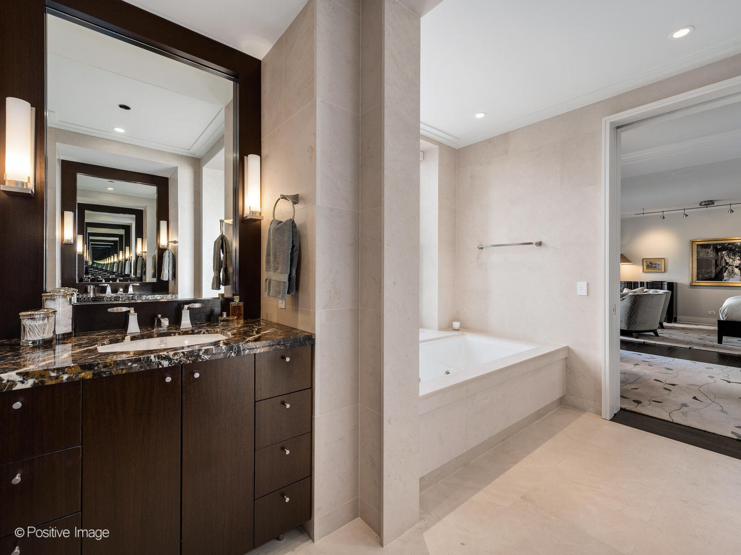 159 East Walton Place, Unit 18A Chicago, IL 60611 - Photo 38 of 54 a en suite bathroom with a bathtub double sink and mirror
